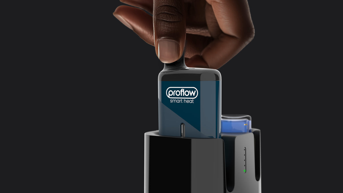 A hand places the Refilla rechargeable & refillable vape into the automatic dock