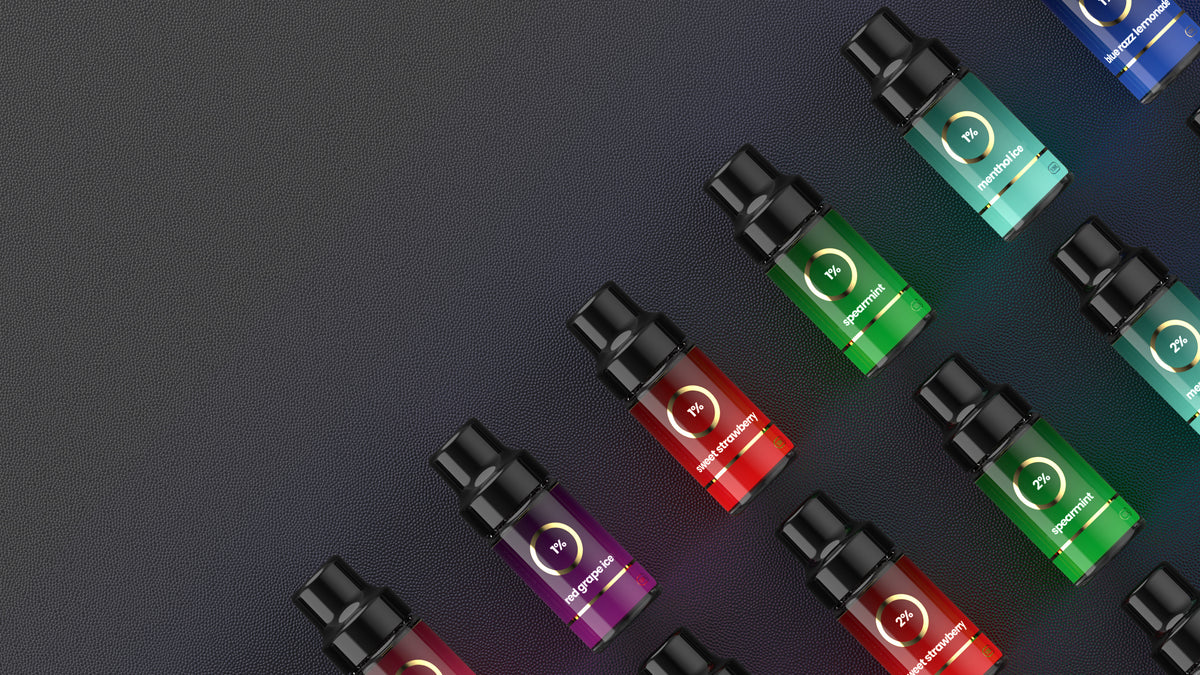 Refilla refillable vape compatible liquid bottles form a colourful pattern on a textured background